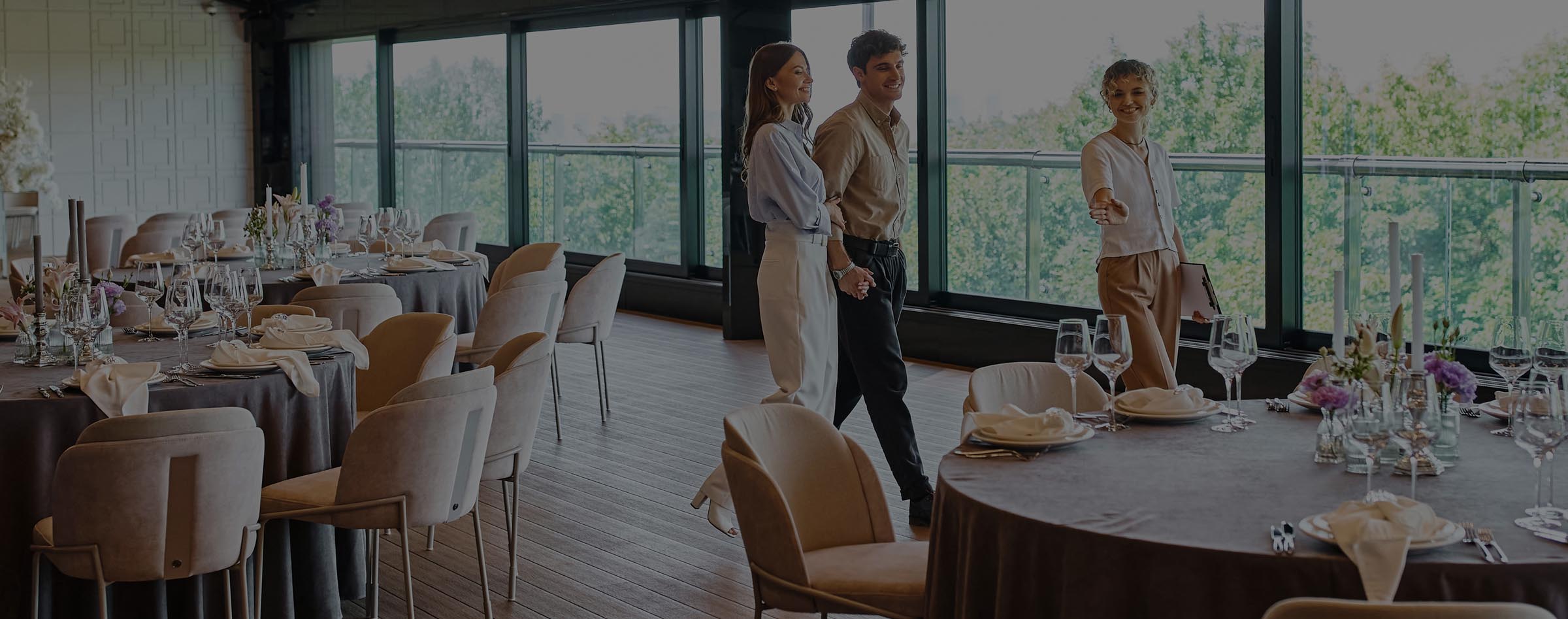 A young couple being shown around a wedding venue